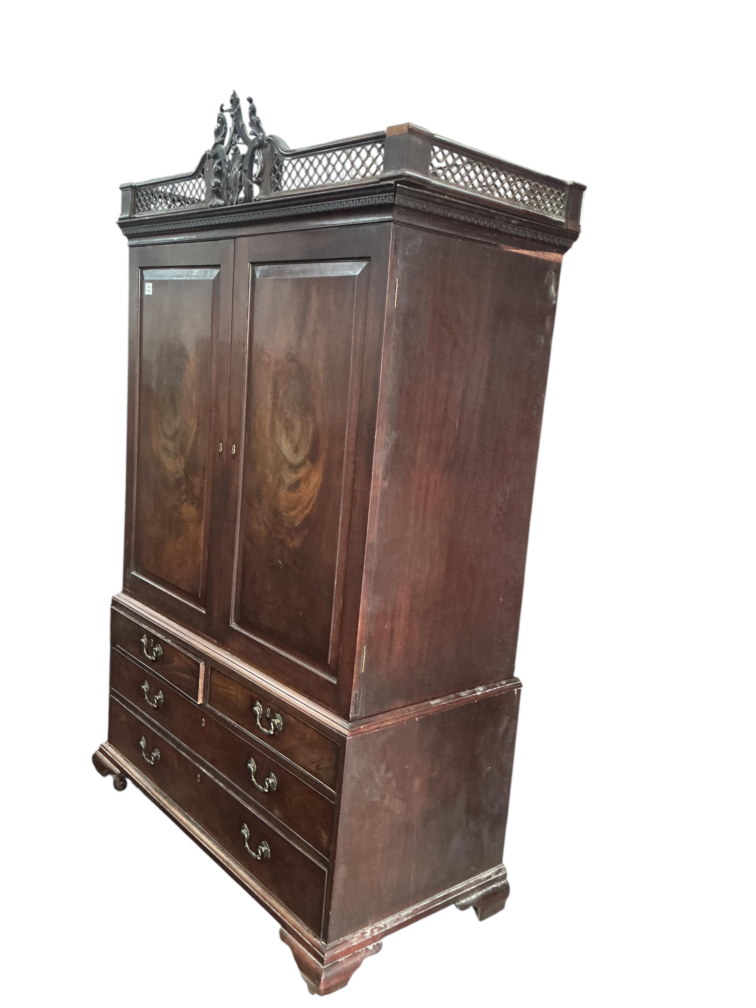A George III Cuban mahogany linen press, lacking trays, converted to a hanging wardrobe, width 124cm, depth 60cm, height 210cm